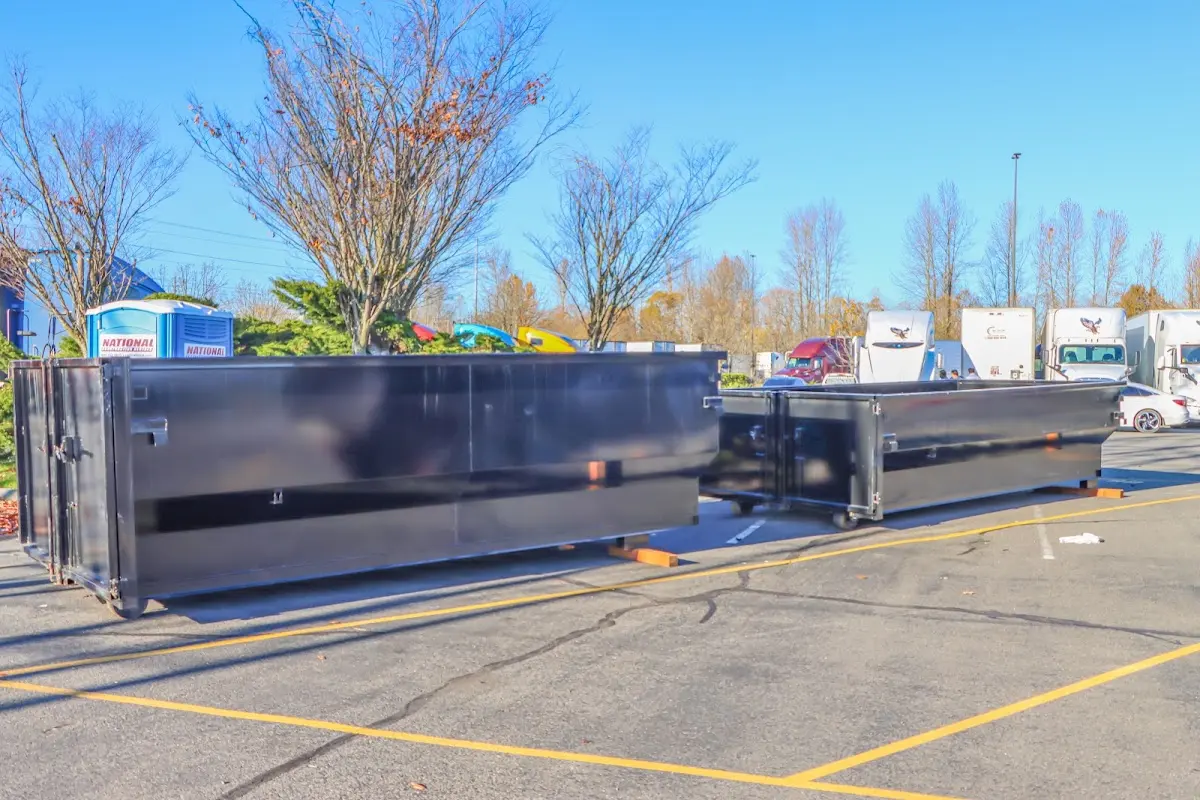 Professional dumpster rental service with roll-off container on residential driveway in Wheeling